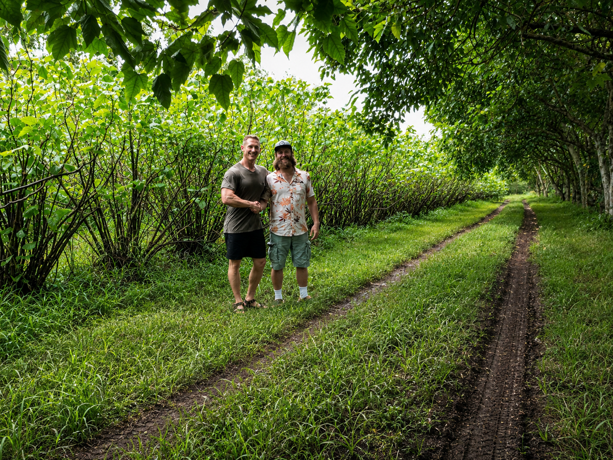 Tyler Blythe and Travis Lowin from Root of Happiness, standing in front of a Kava plantation